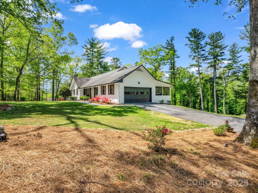 1351 Chanteloup Drive, Hendersonville, NC 28739.  MLS# CAR4250000, YatesRealty ID 24151. 2 car garage and screened porch on the back of the house overlooking the protected conservation easement