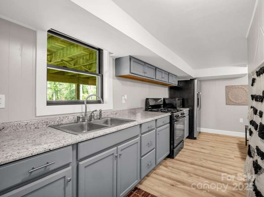 1351 Chanteloup Drive, Hendersonville, NC 28739.  MLS# CAR4250000, YatesRealty ID 24151. Full kitchen in full finished basement