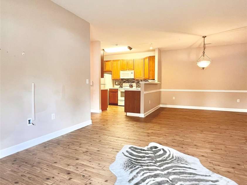 11264 Hyde Pointe Court, Charlotte, NC 28262.  MLS# CAR4190943, YatesRealty ID 24154. Living room opens up to kitchen and dining room