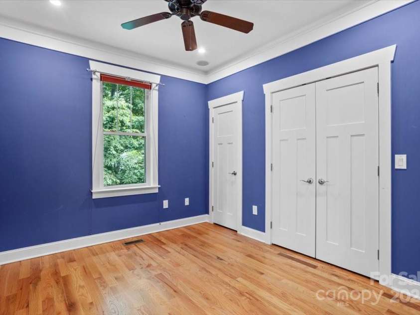 311 Carriage Crest Drive, Hendersonville, NC 28791.  MLS# CAR4263699, YatesRealty ID 24164. Bedroom on the main level, looking at the included adjacent lot.