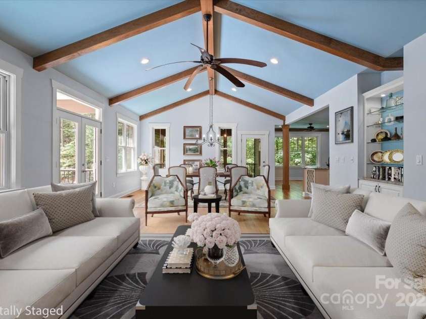 311 Carriage Crest Drive, Hendersonville, NC 28791.  MLS# CAR4263699, YatesRealty ID 24164. Digitally staged living room looking towards the dining room on the main level.