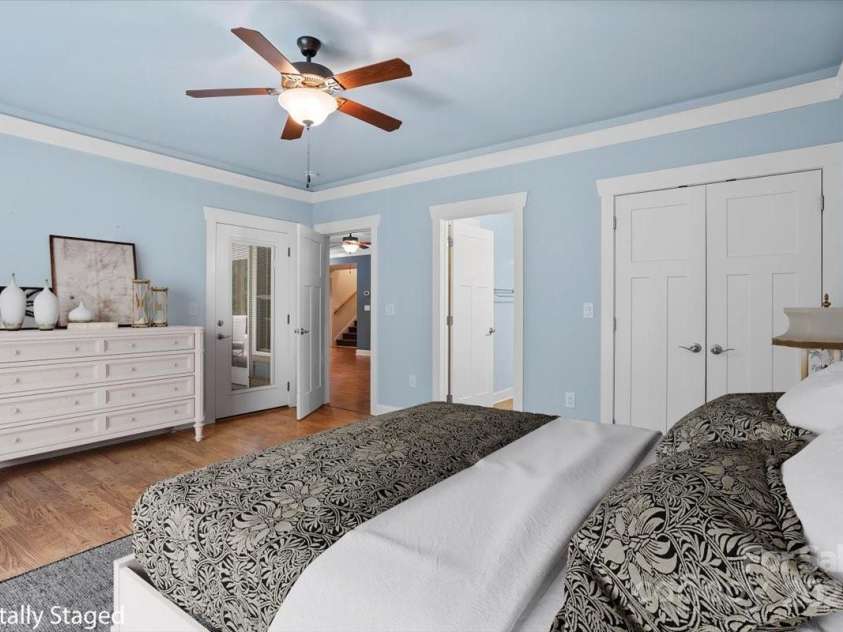 311 Carriage Crest Drive, Hendersonville, NC 28791.  MLS# CAR4263699, YatesRealty ID 24164. Digitally staged lower level bedroom with en suite bathroom.