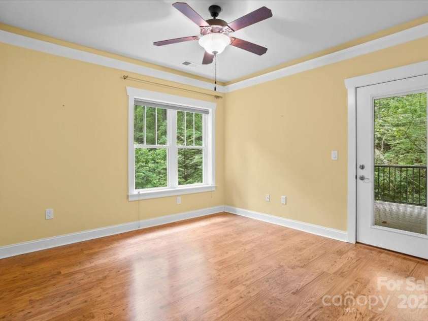 311 Carriage Crest Drive, Hendersonville, NC 28791.  MLS# CAR4263699, YatesRealty ID 24164. Lower level bedroom with access to a private covered porch.
