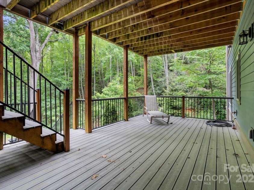 311 Carriage Crest Drive, Hendersonville, NC 28791.  MLS# CAR4263699, YatesRealty ID 24164. Lower level deck off the entertainment room and lower bedroom with en suite.