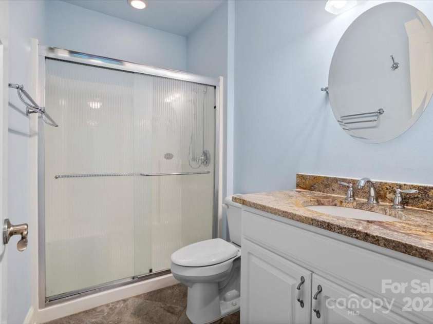 311 Carriage Crest Drive, Hendersonville, NC 28791.  MLS# CAR4263699, YatesRealty ID 24164. Lower level en suite bathroom.