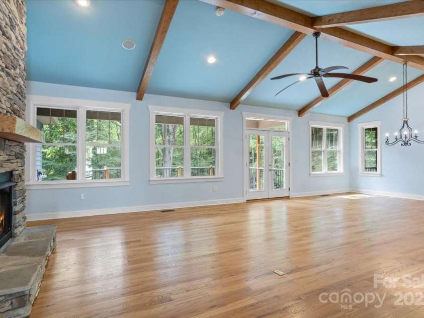 311 Carriage Crest Drive, Hendersonville, NC 28791.  MLS# CAR4263699, YatesRealty ID 24164. Standing in the foyer looking across the living room towards the dining room and the main level porch.