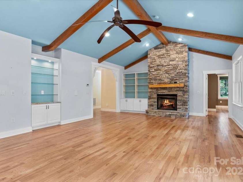 311 Carriage Crest Drive, Hendersonville, NC 28791.  MLS# CAR4263699, YatesRealty ID 24164. View from the dining room looking towards the foyer and main level fireplace.