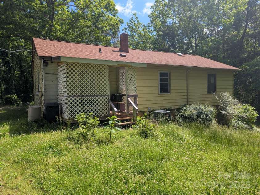 720 New Market Road, Tryon, NC 28782.  MLS# CAR4261255, YatesRealty ID 24169. Back of house