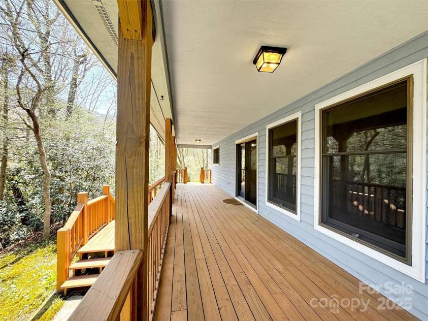 100 Tsali Drive, Waynesville, NC 28785.  MLS# CAR4244909, YatesRealty ID 24175. Front deck overlooking bold stream