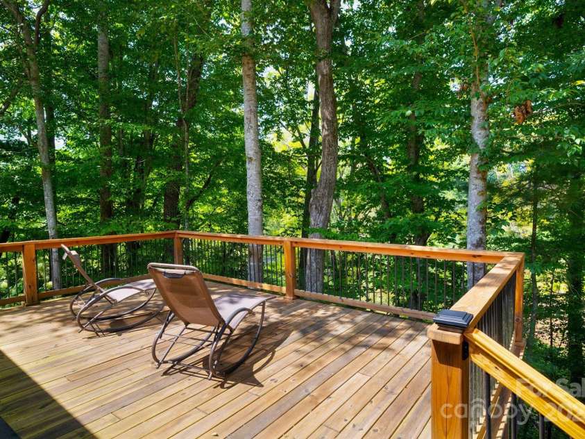 628 Brush Creek Road, Fairview, NC 28730.  MLS# CAR4256769, YatesRealty ID 24181. 19' x 17' deck overlooking forest, pond and stream