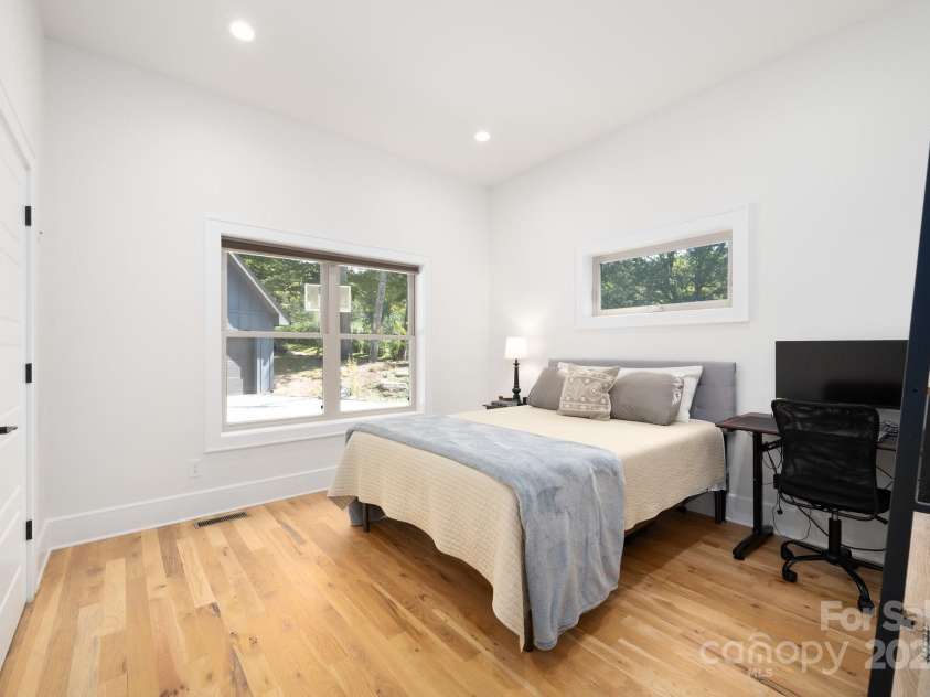 628 Brush Creek Road, Fairview, NC 28730.  MLS# CAR4256769, YatesRealty ID 24181. Bedroom 2 with back yard views