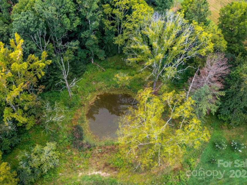 628 Brush Creek Road, Fairview, NC 28730.  MLS# CAR4256769, YatesRealty ID 24181. Birds eye view of the pond