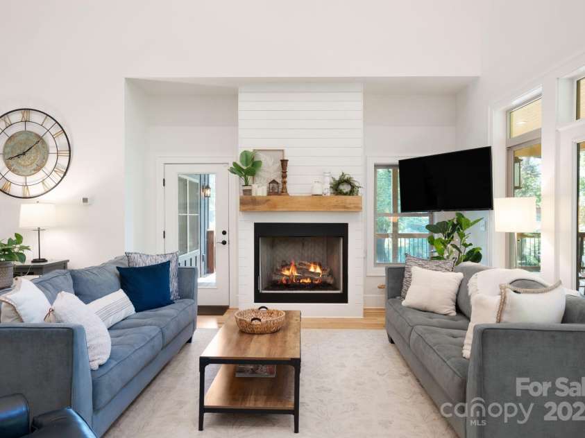 628 Brush Creek Road, Fairview, NC 28730.  MLS# CAR4256769, YatesRealty ID 24181. Living room sitting area with white oak flooring and a lovely gas fireplace