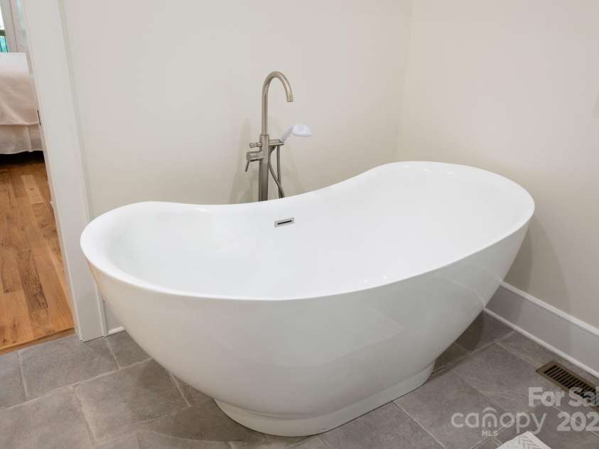628 Brush Creek Road, Fairview, NC 28730.  MLS# CAR4256769, YatesRealty ID 24181. Luxurious soaking tub in primary bathroom
