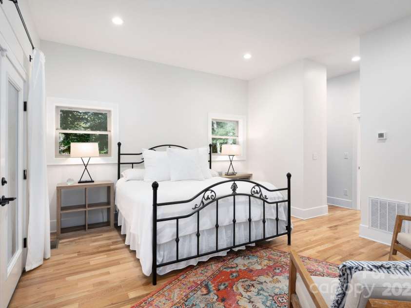 628 Brush Creek Road, Fairview, NC 28730.  MLS# CAR4256769, YatesRealty ID 24181. Primary suite with French doors leading out to the picturesque front porch