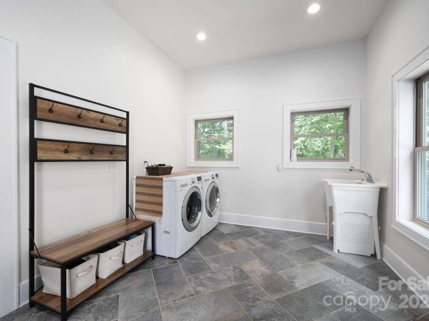 628 Brush Creek Road, Fairview, NC 28730.  MLS# CAR4256769, YatesRealty ID 24181. Spacious Mudroom with LG Washer/Dryer and utility sink