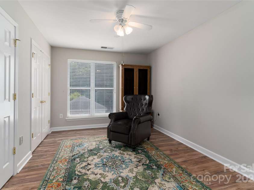 819 Northeast Drive, Davidson, NC 28036.  MLS# CAR4276218, YatesRealty ID 24193. Bedroom 3 has laminate flooring and ceiling fan.