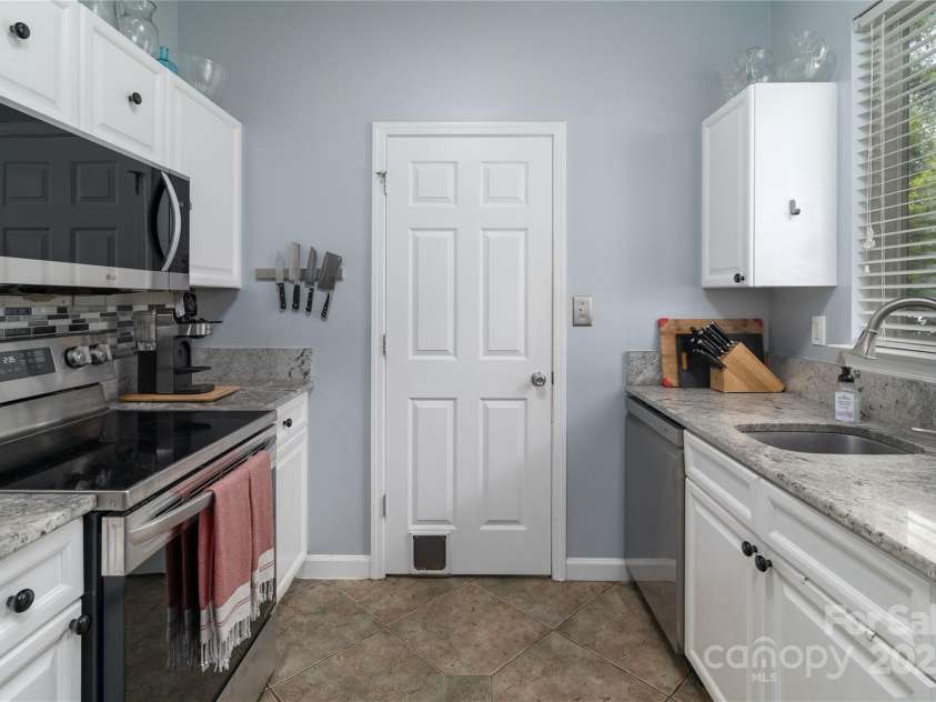 819 Northeast Drive, Davidson, NC 28036.  MLS# CAR4276218, YatesRealty ID 24193. Laundry Room off kitchen leads to laundry room with full size washer/dryer.