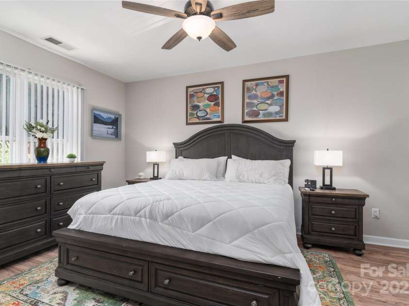 819 Northeast Drive, Davidson, NC 28036.  MLS# CAR4276218, YatesRealty ID 24193. Primary bedroom is spacious and has  lots of light and ceiling fan.