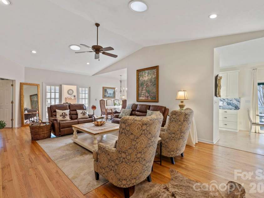 24 Country Meadows Lane, Hendersonville, NC 28792.  MLS# CAR4336584, YatesRealty ID 2420. Open and airy living space with multiple seating areas, ceiling fan, and seamless flow into adjacent rooms, ideal for everyday living and entertaining