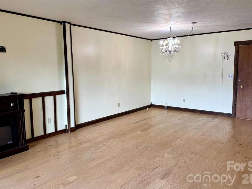427 6th Avenue, Hendersonville, NC 28739.  MLS# CAR4379702, YatesRealty ID 2420. Large living and dining area. Electric fireplace to convey.