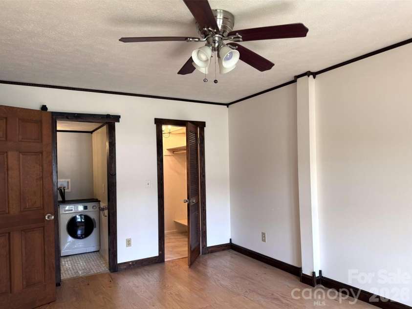 427 6th Avenue, Hendersonville, NC 28739.  MLS# CAR4379702, YatesRealty ID 2420. Primary bedroom includes walk-in closet and half-bath with in-unit washer.
