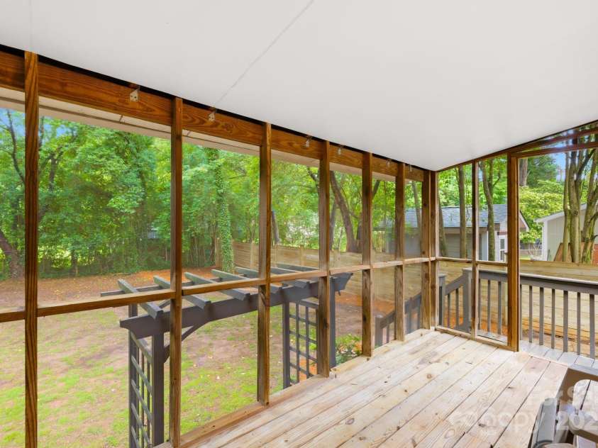 4114 Stacy Boulevard, Charlotte, NC 28209.  MLS# CAR4258425, YatesRealty ID 24208. At the rear of the home, a spacious screened porch offers a comfortable space for outdoor relaxation, overlooking the mostly fenced backyard.