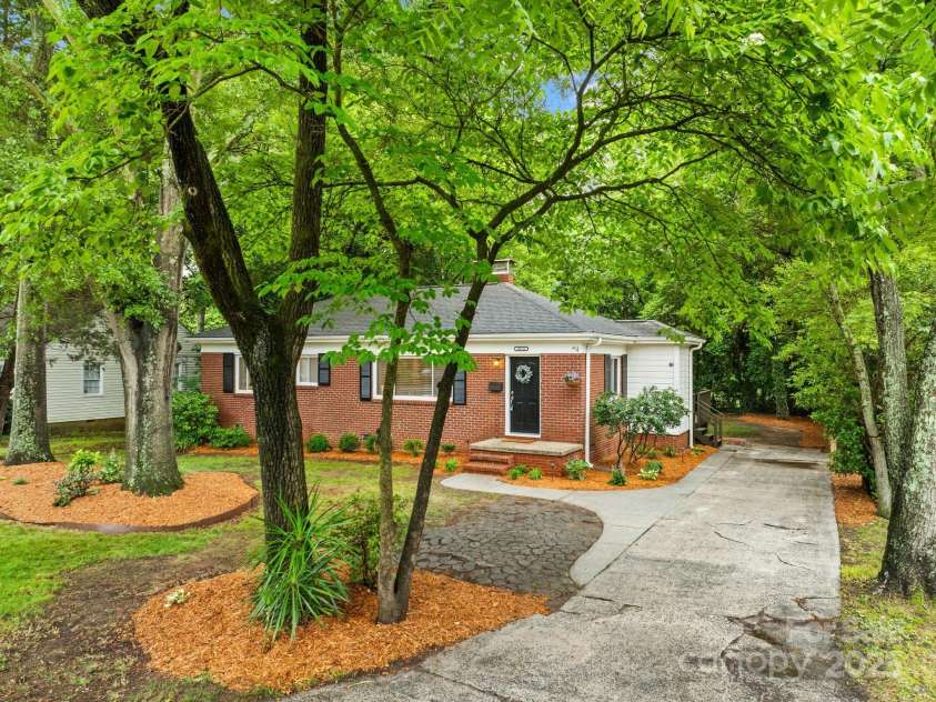 4114 Stacy Boulevard, Charlotte, NC 28209.  MLS# CAR4258425, YatesRealty ID 24208. Fresh landscaping and a neatly maintained lawn with mature trees provides shade and provides curb appeal.