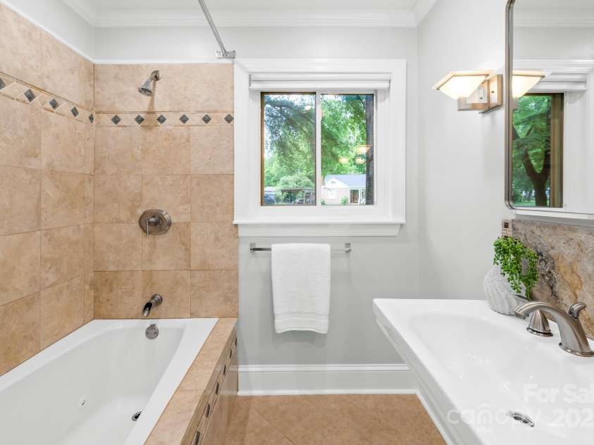4114 Stacy Boulevard, Charlotte, NC 28209.  MLS# CAR4258425, YatesRealty ID 24208. Great bathroom with tiled shower and pedestal sink.