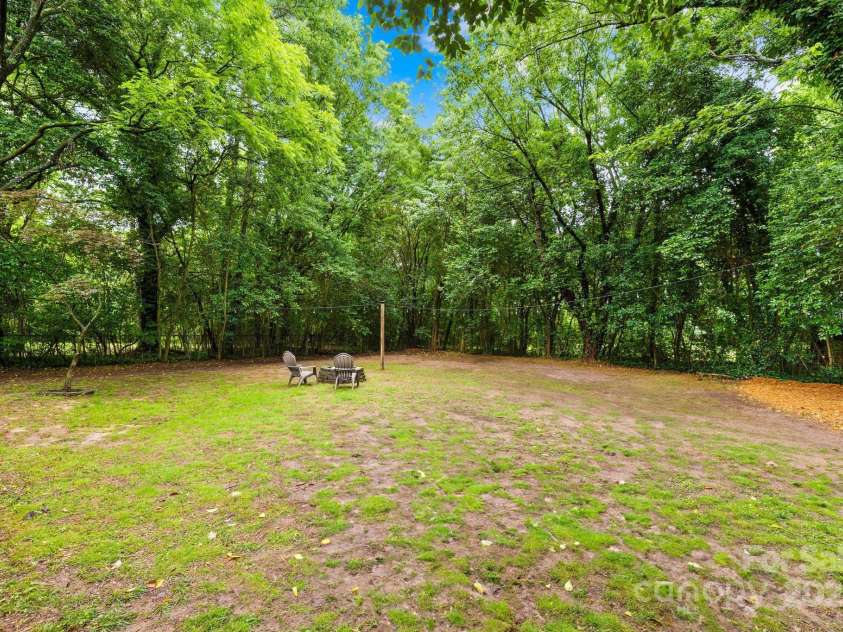 4114 Stacy Boulevard, Charlotte, NC 28209.  MLS# CAR4258425, YatesRealty ID 24208. Nearly 1/3 of an acre! Private, level lot with mature trees and a fire pit to enjoy with friends!