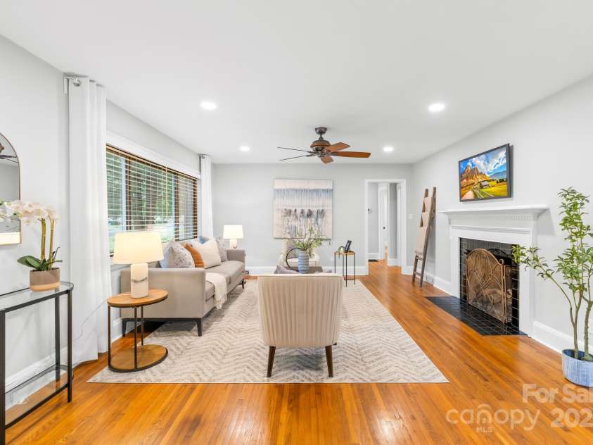 4114 Stacy Boulevard, Charlotte, NC 28209.  MLS# CAR4258425, YatesRealty ID 24208. The huge living room offers ample space, highlighted by original hardwood floors, recessed lighting, a cozy fireplace and large windows that allow natural light to fill the room.