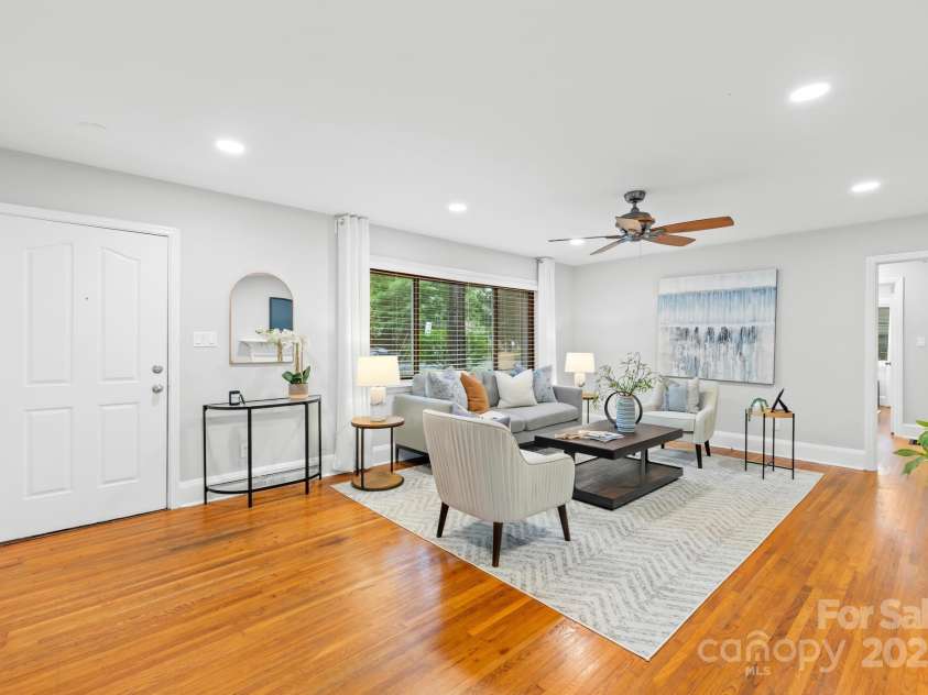 4114 Stacy Boulevard, Charlotte, NC 28209.  MLS# CAR4258425, YatesRealty ID 24208. The original hardwood floors and recessed lighting create a warm and welcoming space for relaxation and entertaining guests in the living room.