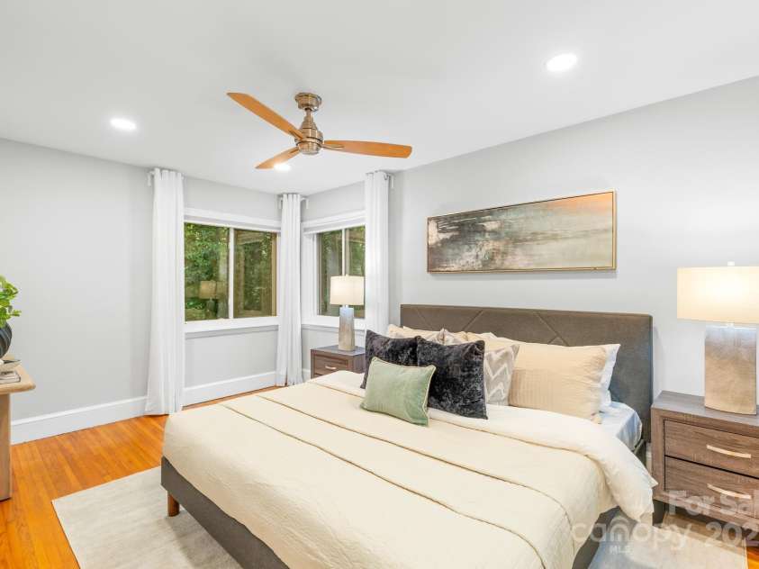 4114 Stacy Boulevard, Charlotte, NC 28209.  MLS# CAR4258425, YatesRealty ID 24208. The primary bedroom features original hardwood flooring, recessed lighting, a ceiling fan and neutral wall tones, offering a cozy and inviting retreat.