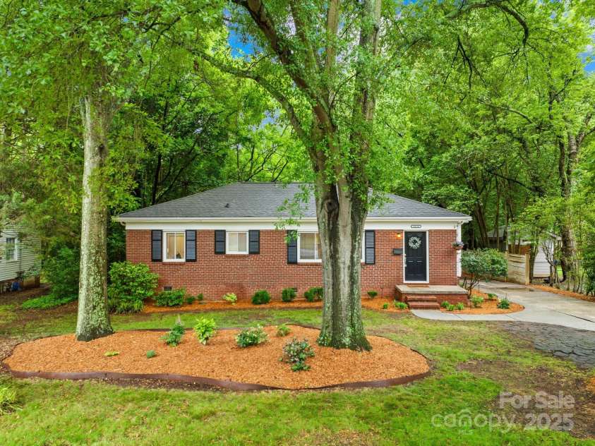 4114 Stacy Boulevard, Charlotte, NC 28209.  MLS# CAR4258425, YatesRealty ID 24208. Welcome home to 4114 Stacy Blvd in popular Collins Park! Surrounded by mature trees, the home's traditional red brick exterior exudes timeless appeal, complemented by black shutters and a welcoming front porch.
