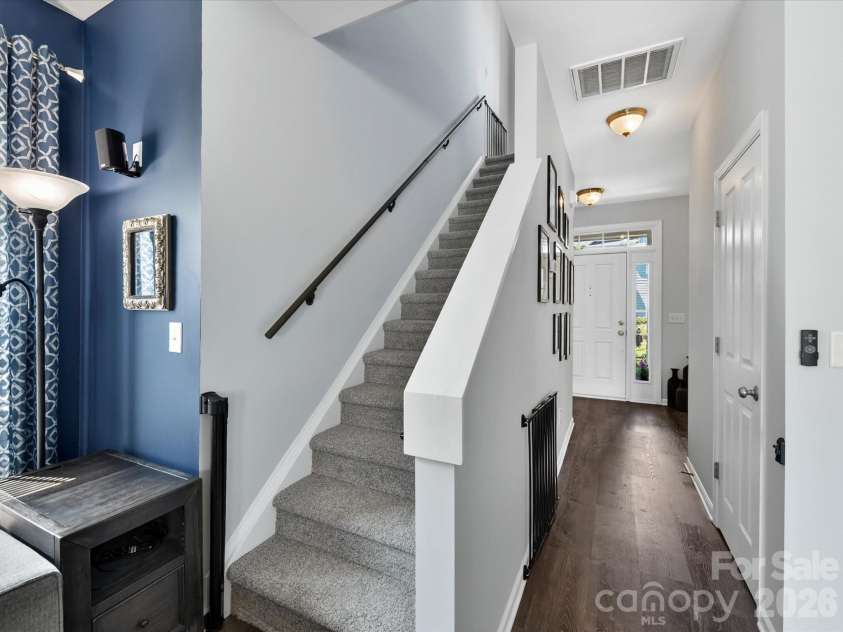 15224 Waterfront Drive, Huntersville, NC 28078.  MLS# CAR4374936, YatesRealty ID 24231. Open and airy stairwell with modern railing, neutral finishes, and seamless flow connecting the main living areas to the upper level.