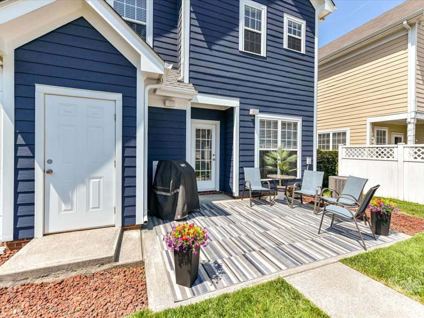 15224 Waterfront Drive, Huntersville, NC 28078.  MLS# CAR4374936, YatesRealty ID 24231. Private, low-maintenance back patio perfect for outdoor entertaining, featuring a fenced yard, seating area, and space to relax or grill.