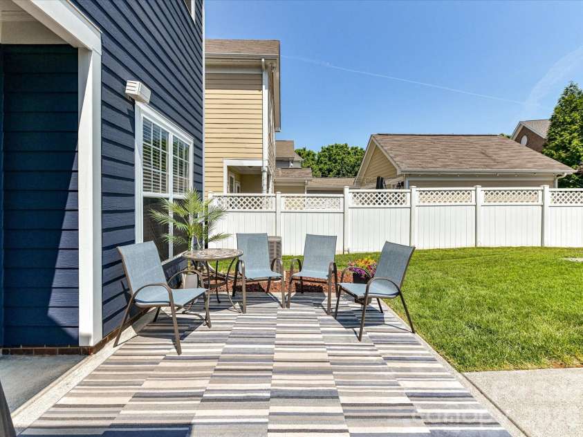 15224 Waterfront Drive, Huntersville, NC 28078.  MLS# CAR4374936, YatesRealty ID 24231. Private, low-maintenance back patio perfect for outdoor entertaining, featuring a fenced yard, seating area, and space to relax or grill.