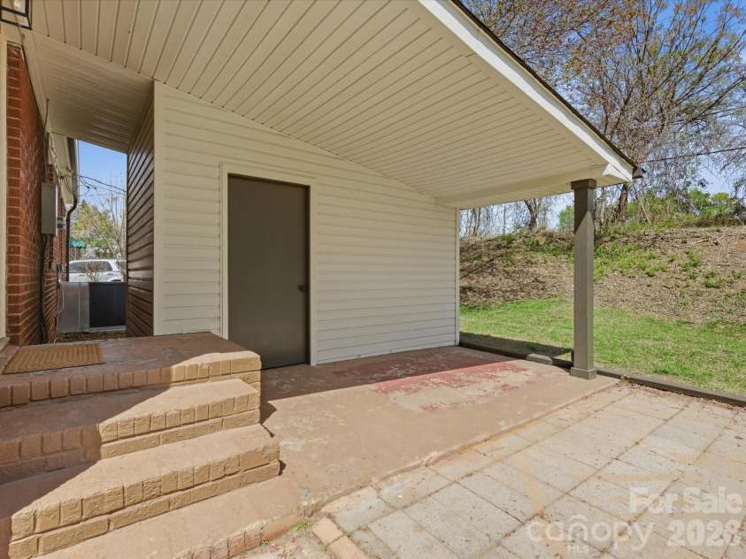 4946 Morgan Street, Charlotte, NC 28208.  MLS# CAR4361415, YatesRealty ID 24232. Large outdoor room for storage and laundry! All covered from back door into this room and an area for sitting under cover!