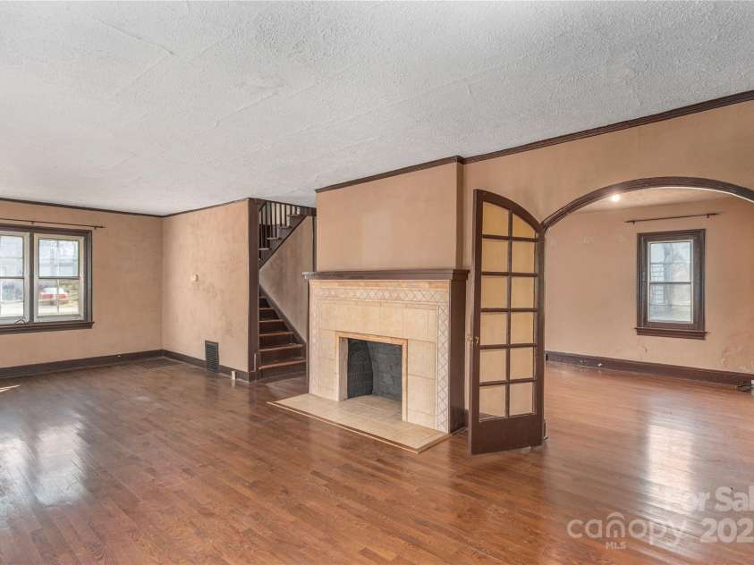 202 Alexander Avenue, Swannanoa, NC 28778.  MLS# CAR4234591, YatesRealty ID 2424. Grand Livingroom all original doors and fireplace