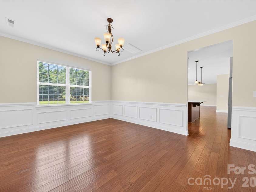 1008 Spring Rose Lane, Matthews, NC 28104.  MLS# CAR4382906, YatesRealty ID 24258. Dining area adjacent to kitchen featuring backyard views and seamless connection to the main living areas.