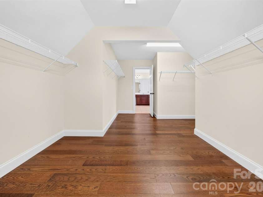 1008 Spring Rose Lane, Matthews, NC 28104.  MLS# CAR4382906, YatesRealty ID 24258. Expansive walk in closet featuring natural light and generous storage space.
