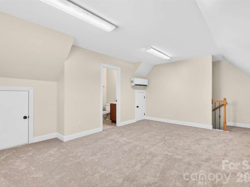 1008 Spring Rose Lane, Matthews, NC 28104.  MLS# CAR4382906, YatesRealty ID 24258. Finished flex space above detached 2 car garage featuring carpet, full bathroom, and versatile space ideal for a home office, studio, or additional flex use.