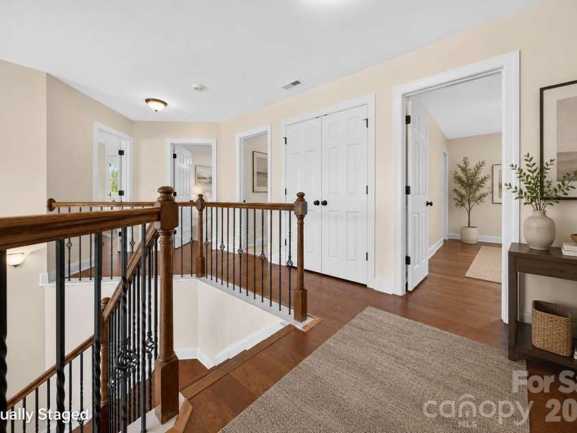 1008 Spring Rose Lane, Matthews, NC 28104.  MLS# CAR4382906, YatesRealty ID 24258. Open upper level landing overlooking the foyer and connecting the primary suite with additional bedrooms, with all five bedrooms thoughtfully situated on the upper level.