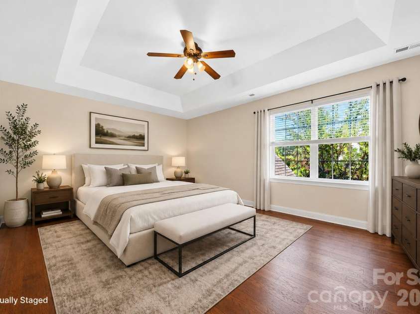 1008 Spring Rose Lane, Matthews, NC 28104.  MLS# CAR4382906, YatesRealty ID 24258. Primary suite featuring tray ceiling, ensuite bath with separate tub and shower, and expansive walk in closet.