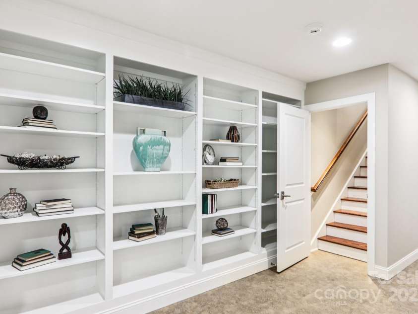 119 Hawthorn Drive, Hendersonville, NC 28791.  MLS# CAR4260903, YatesRealty ID 24278. Lower level Hall Built-in Bookcases
