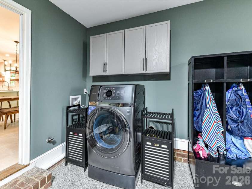 9912 Hanover Hollow Drive, Charlotte, NC 28210.  MLS# CAR4380529, YatesRealty ID 24283. Laundry conveniently located off kitchen in garage with additional storage.