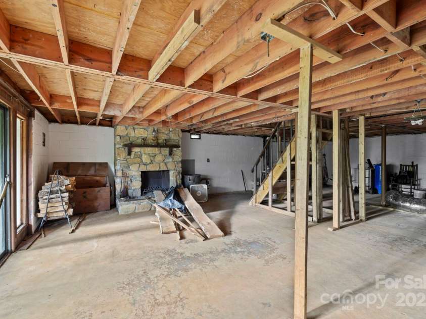 193 Falls View Drive, Lake Toxaway, NC 28747.  MLS# CAR4267831, YatesRealty ID 24289. Basement with stone fireplace