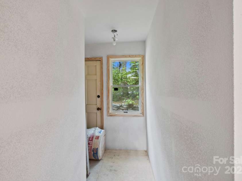 193 Falls View Drive, Lake Toxaway, NC 28747.  MLS# CAR4267831, YatesRealty ID 24289. Hallway to side entrance and primary suite