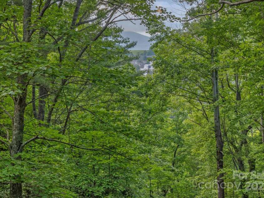 193 Falls View Drive, Lake Toxaway, NC 28747.  MLS# CAR4267831, YatesRealty ID 24289. Hear and see Toxaway Falls from the decks