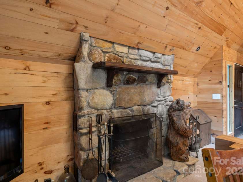 193 Falls View Drive, Lake Toxaway, NC 28747.  MLS# CAR4267831, YatesRealty ID 24289. Stone fireplace #1 - family room